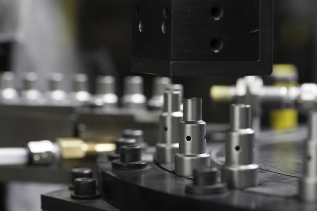 Close up of precision tooling and formed metal components during production.