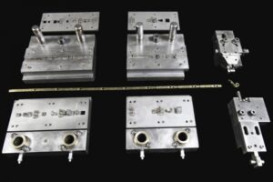 Slide formed metal components on black background.