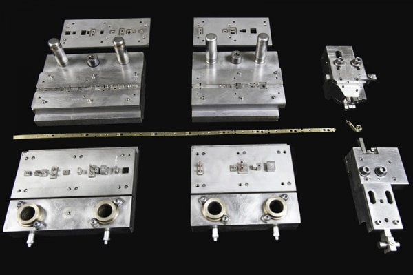 Slide formed metal components on black background.