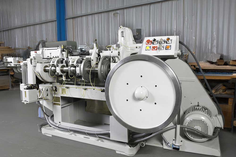 Industrial slide forming machine with multiple rollers and drive components, used for continuous metal forming in a manufacturing facility.